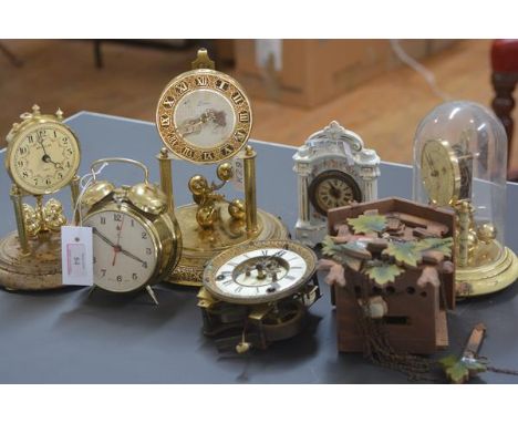 A group of five clocks including two 100 day clocks, a painted wooden wall-mounted cuckoo clock, transfer-printed china clock