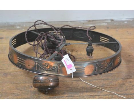 An Edwardian copper rise and fall hanging light, circular (lacking shade). Diameter 47cm
