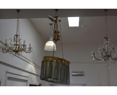 A brass three-light rise and fall ceiling lamp, with brass rose, the ring pierced and chased with square bosses and with frin