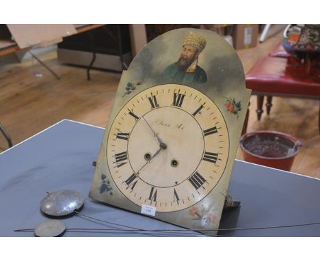A 19th century painted longcase clock dial, decorated in the arch with a turbanned man, together with longcase clock pendulum