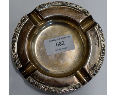 A 4½" DIAMETER STERLING SILVER ASHTRAY WITH CELTIC STYLE DECORATION, WITH BIRMINGHAM ASSAY MARKS, MAKER MARKS FOR ADIE BROTHE