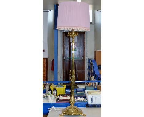 A 56" ORNATE BRASS COLUMNED STANDARD LAMP ON TRIPLE FEET WITH SHADE     