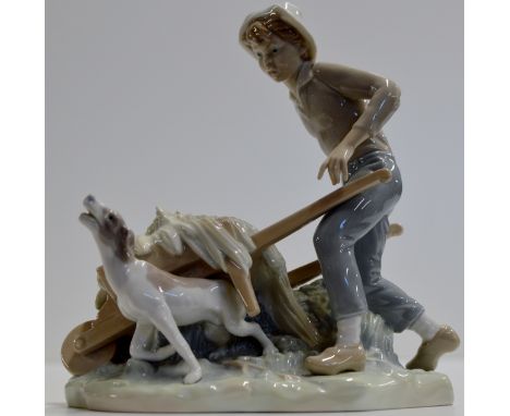 AN 8½" LLADRO PORCELAIN FIGURE ORNAMENT MODELLED AS A YOUNG MAN WITH A WHEELBARROW & A DOG     