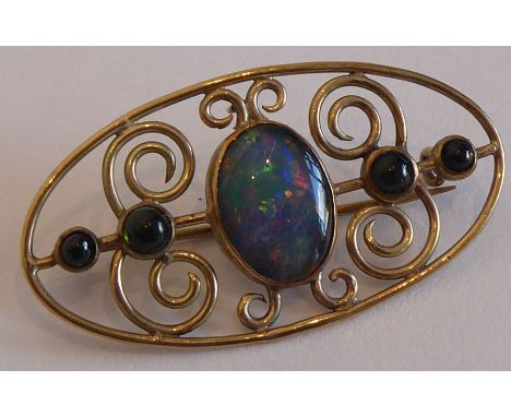 A 9-carat yellow-gold oval brooch; centrally set with a vertical cabouchon opal flanked by two further graduated circular har