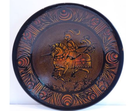 A good Poole Pottery charger; shape No. 54 from the Aegean Range and decorated with a knight on horseback with lance at full 