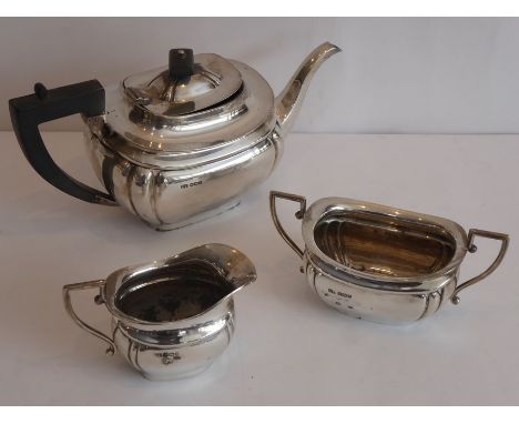 A three-piece hallmarked silver tea service comprising teapot, two-handled sugar and milk jug, makers mark E.V., (for Elizabe