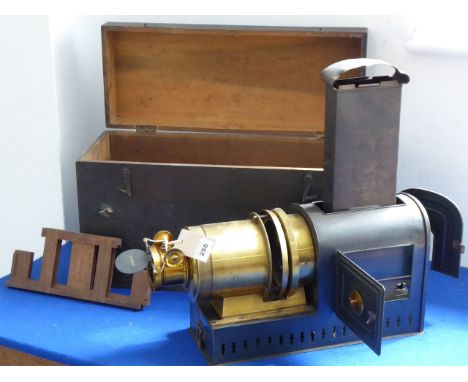 A 19th century stained-pine-cased gilt-metal-mounted magic lantern by Optimus (London); fully adjustable and seemingly in ver