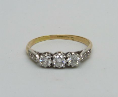 An 18ct gold ring set with nine diamonds, 2.2g, T 