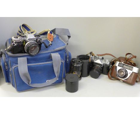 An Olympus OM10 camera with accessories and camera bag, a Peacemaker camera, a Zenit camera and two lenses 