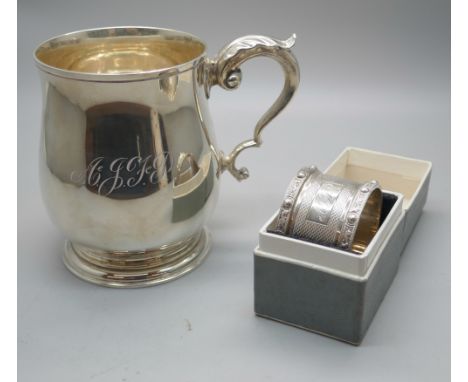 A silver mug, Birmingham 1970, 226g, and a boxed silver napkin ring with dragon detail, 39g 