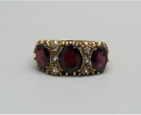 A silver gilt and garnet ring, Q 