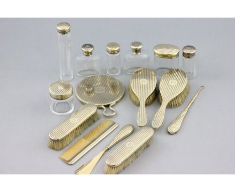 Fifteen Piece Dressing Table Set comprising Silver Gilt Backed Hand Mirror, Four Brushes, Comb, plus Silver Gilt Handled Butt