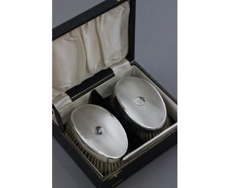 Cased Silver Backed Grooming Set comprising Two Oval Brushes & a Comb, engine turned with initials HK, Birmingham 1956, W G S