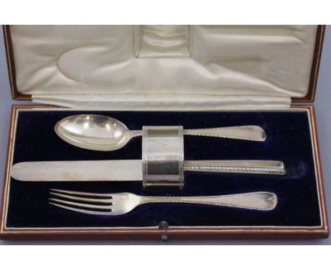 Cased Cutlery Set comprising Spoon, Fork, Knife and Napkin Ring, London 1931, Goldsmith & Silversmiths Company Ltd