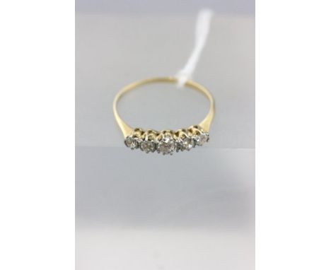 Unmarked Yellow Metal Ring set with a row of Five Diamonds