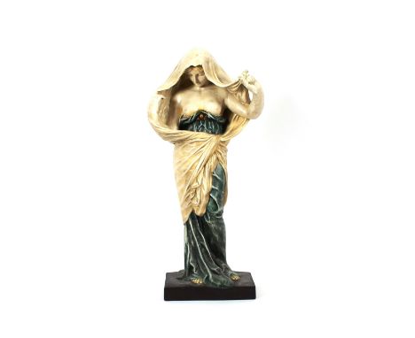 A tall pottery figure depicting a partly naked woman, sheltering under a cloak, 75cms high&nbsp;