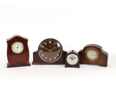 An Edwardian inlaid mahogany timepiece; two Bakelite mantel clocks; and an oak cased clock