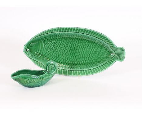 A Sarreguemines green glazed fish shaped serving dish, and matching sauce boat, (2)