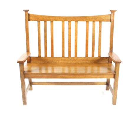 An oak Arts &amp; Crafts design railback three seater bench, raised on square section supports united by stretchers, 126cms w