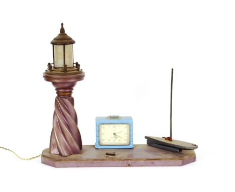 An Art Deco clock / table lamp, in the form of a lighthouse and boat, 41cm long