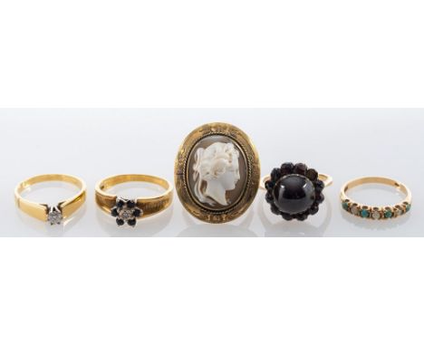 Five rings, including: a carved shell cameo ring, stamped 9ct, ring size M; a diamond single stone ring, the brilliant cut di