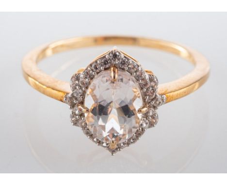 A 9ct gold ring, with an oval, mixed-cut, light brown topaz and CZ surround, ring size N, total weight ca. 2.1gms.

