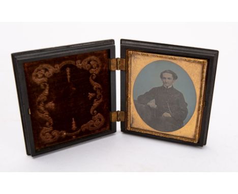 Victorian Photography, a cased hand tinted ambrotype portrait of a seated gentleman, with a Bris Durci ornate case. 


