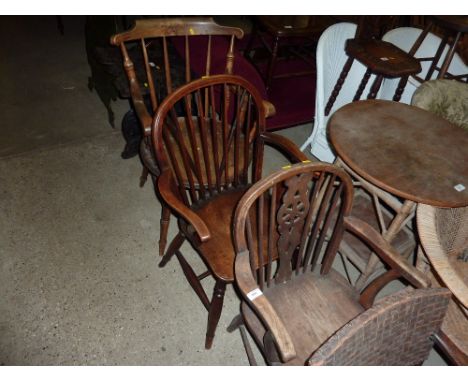 Two elm seated elbow chairs; and a stick back chair 