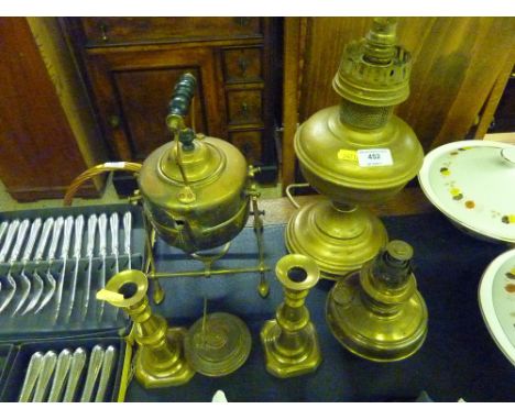 A quantity of brassware to include a pair of candlesticks, a spirit kettle on stand, an oil lamp etc.