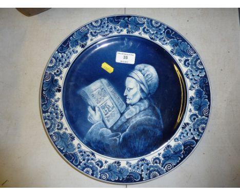 A Delft blue and white portrait plaque depicting Rembrandt's mother, 13" dia.