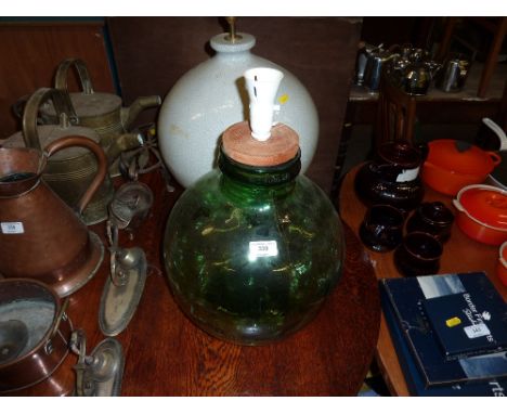 A large crackle glazed table lamp base; and a green glass carboy converted to a table lamp