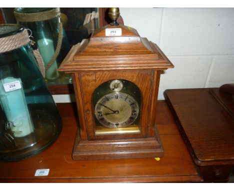 An oak cased three hole bracket clock with brass dial 