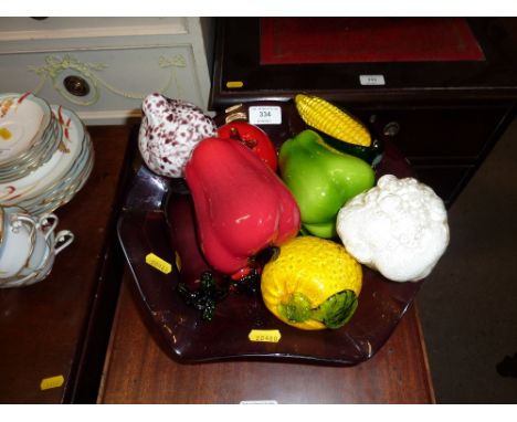 An amethyst glass fruit bowl with glass fruit 