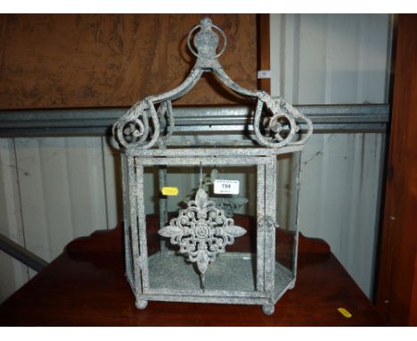 A metal and glass candle lantern 