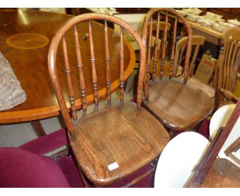 A pair of elm seated stick back chairs 