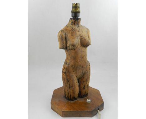A carved wooden table lamp, modelled as a nude female torso, set on octagonal base, H.37cm
