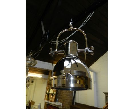 A Contemporary industrial chrome ceiling light, in the form of a spotlight. 