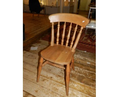 A set of four 20th century pine stick back dining chairs.