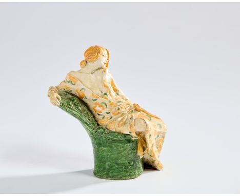 Manner of Susi Singer   Model of a woman reclining on chaise, circa 1930/40  Glazed stoneware  14.5cm high      Condition Rep