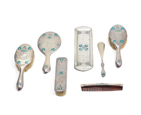Jessie M. King for Liberty & Co.   Dressing table set comprising hand mirror, three brushes, tray, comb and shoe horn, with o