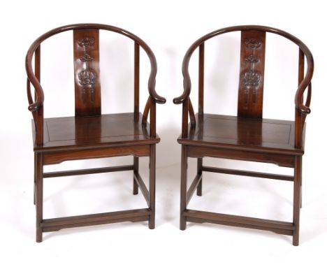A pair of Chinese hardwood chairs, the backs carved with bat and fish (2)Overall condition good light wear. structurally soun