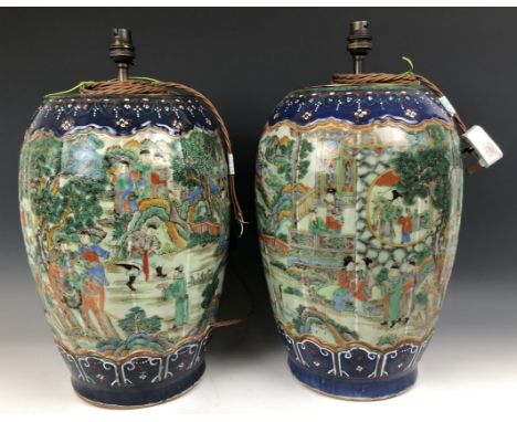 A large pair of Chinese vases, of lobed ovoid form, decorated figures in enamel colours, drilled and adapted into lamps, 38 c