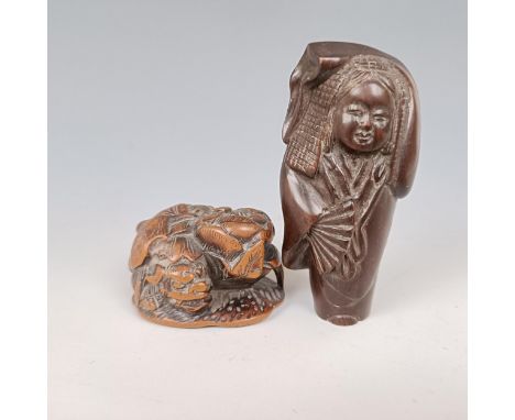 A carved wooden netsuke, in the form of a dragon, 4 cm wide, and another of a figure, 7 cm (2) 