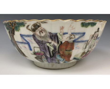 A set of three Chinese bowls, of lobed circular form, decorated figures in famille rose enamel colours, painted seal marks to