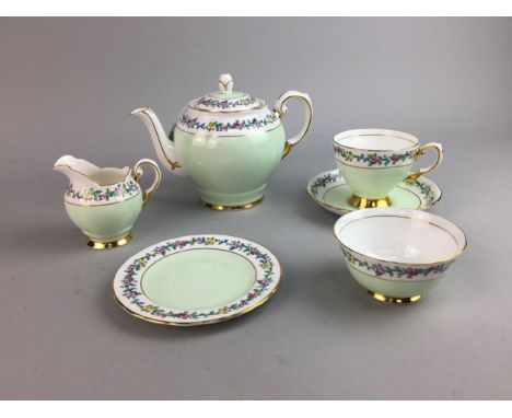 TUSCAN TEA SERVICE, with green, floral and gilt decoration, comprising tea pot, two cups and saucers, cream, sugar and side p