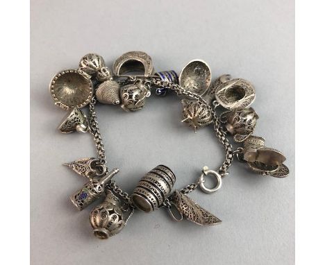 PORTUGUESE FILIGREE CHARM BRACELET, populated with various charms including a bottle, fish, hats and umbrella, most with enam