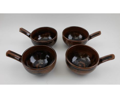 Michael Leach, A set of four studio pottery glazed stoneware, single handled bowls, each impressed with the "Y" mark