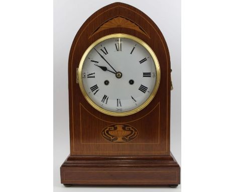 An Edwardian mahogany cased mantel clock, lancet shape, with marquetry inlay including an urn just under the dial, brass hand