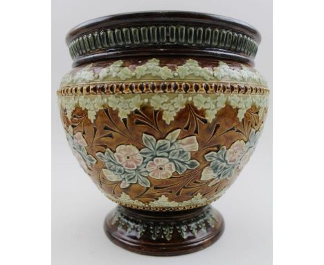 A Royal Doulton Lambeth stoneware planter, leaf bordered and floral applied, on an incised glazed coffee ground, impressed ma