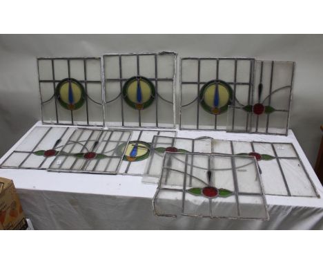A collection of ten leaded light window panels, central coloured glass details, 49cm square